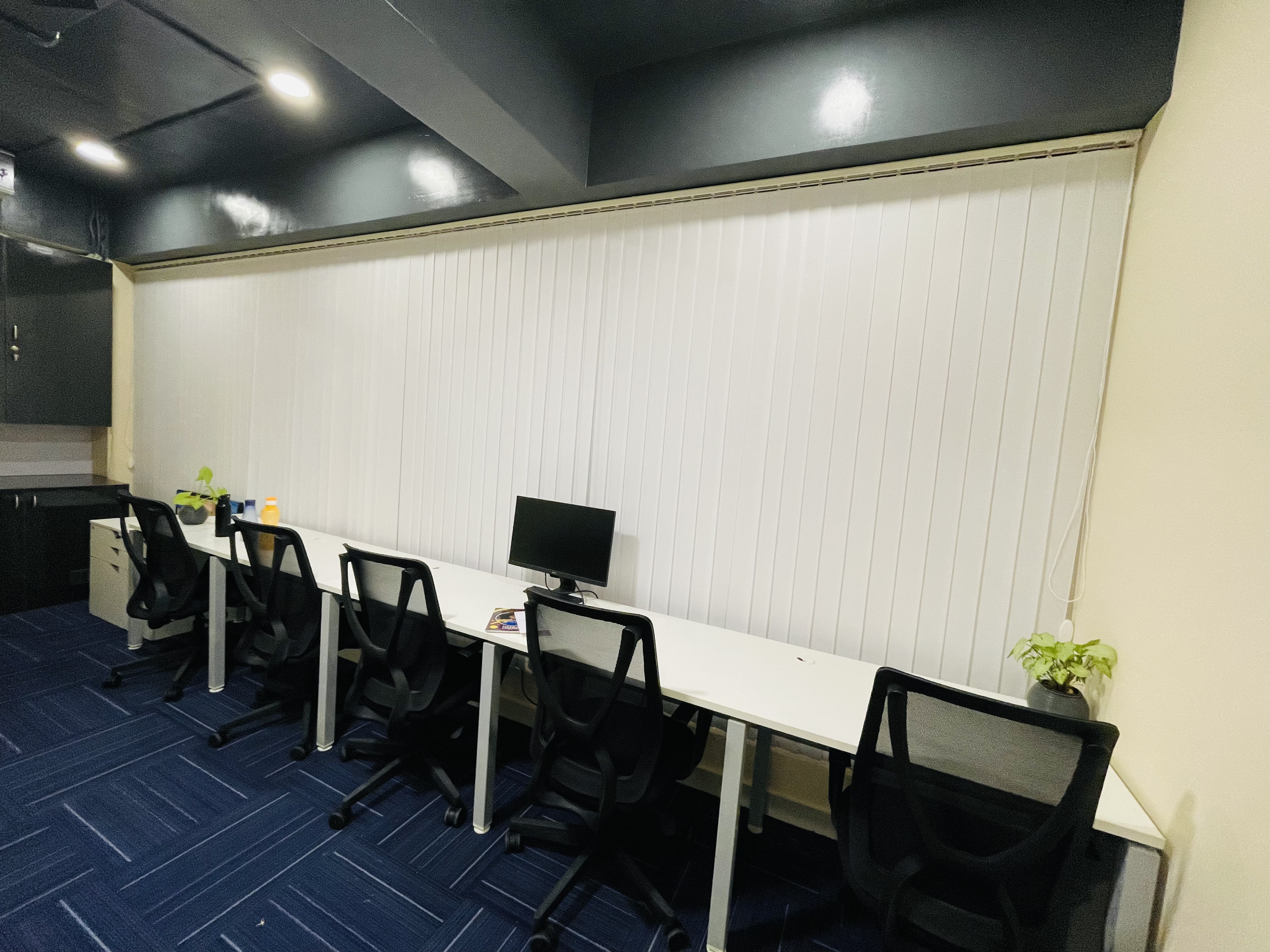 Row of dedicated desks with blue carpet