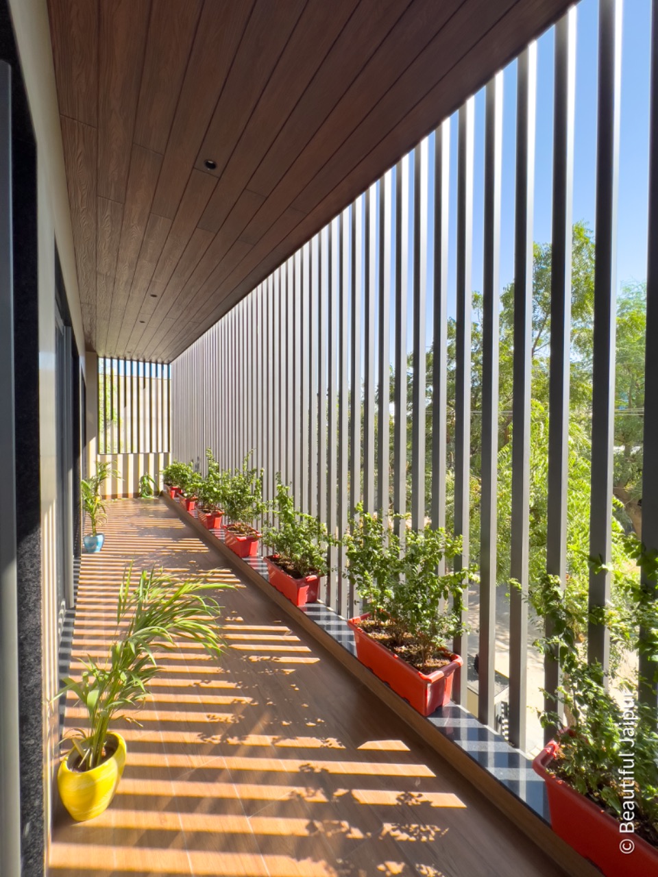 Bright open terrace with red flower pots